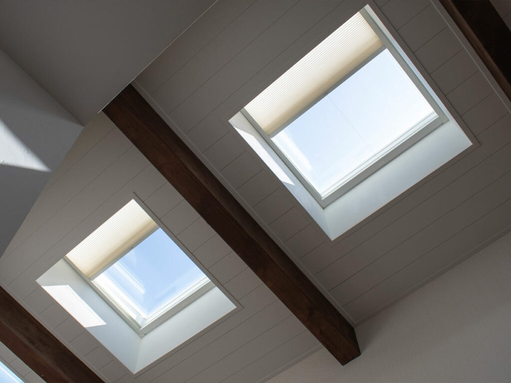 half open skylights with a trackglide honeycomb shade