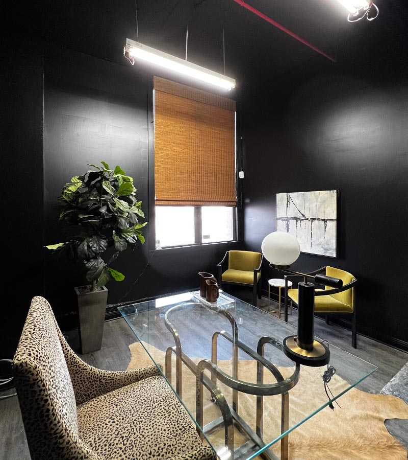 bowery & bash black sitting room with provenance woven wood shades