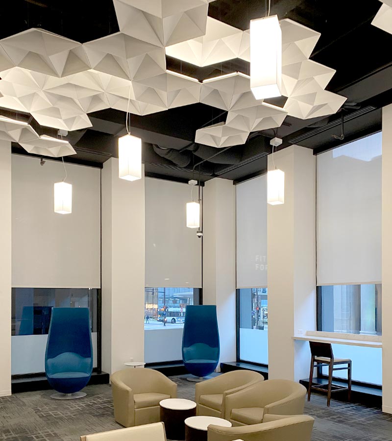 commercial lobby space with designer roller shades and modern ceiling lights