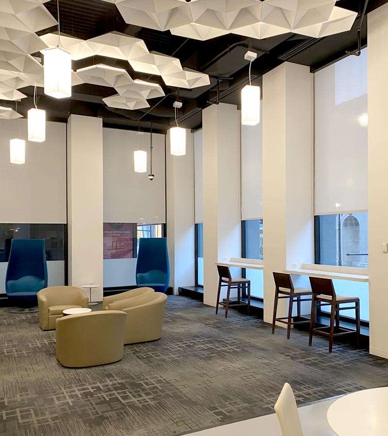 commercial lobby space with designer roller shades and modern ceiling lights