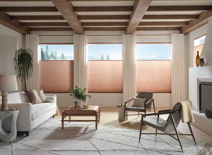 living room design with peach colored window shades and cream drapes