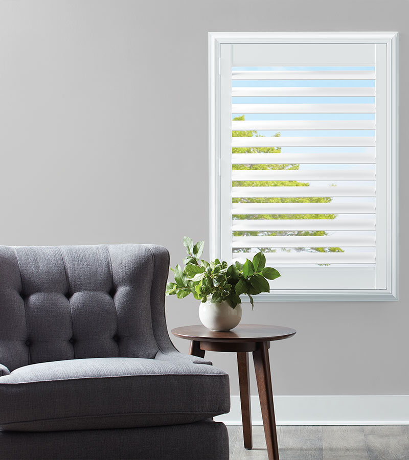 white composite shutter next to gray chair and potted plant