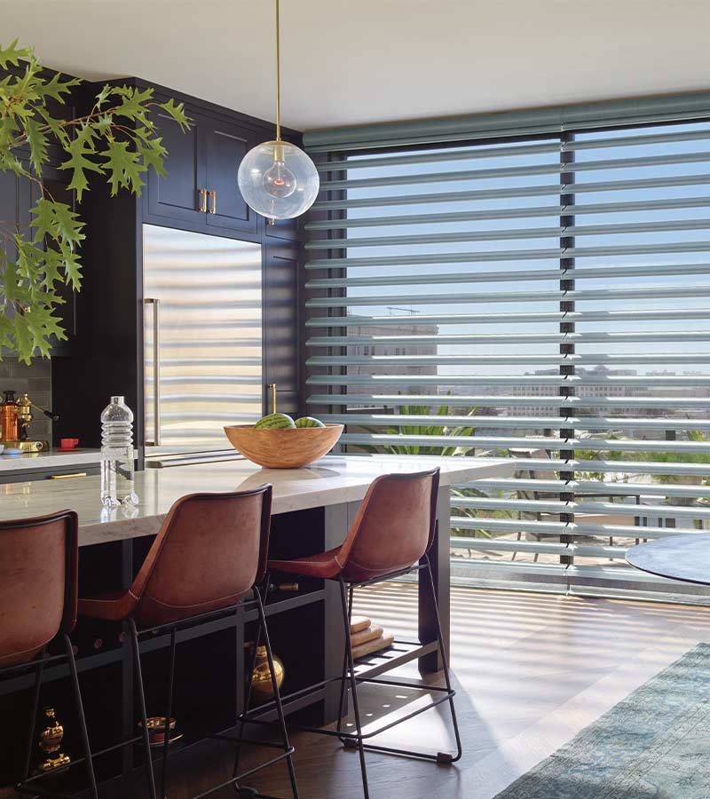 view of bar area with light coming through floor to ceiling window blinds