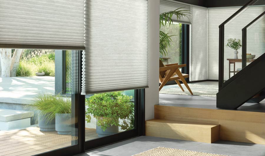 gray honeycomb shades on black trim windows 