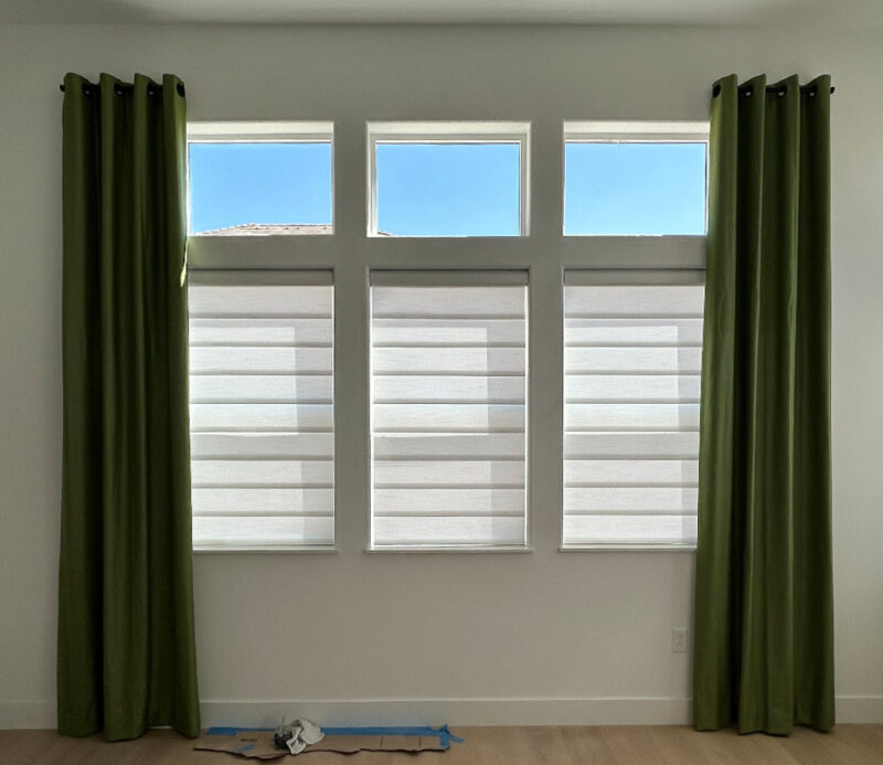 green custom drapery with window shades