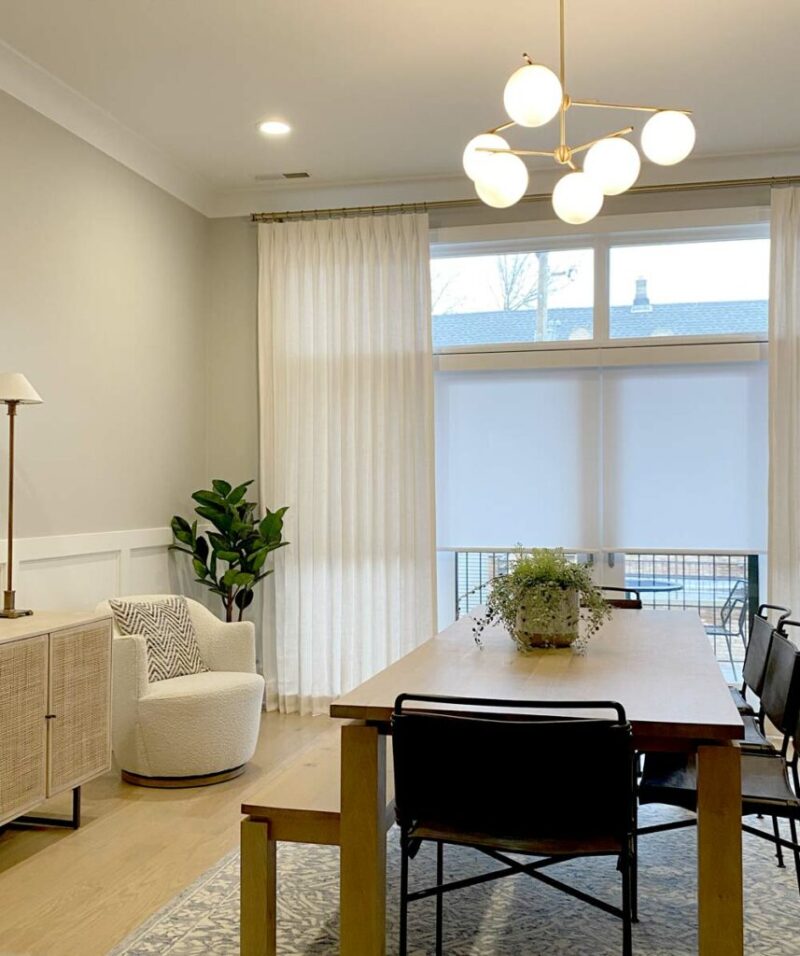 modern drapery with roller shades in dining room
