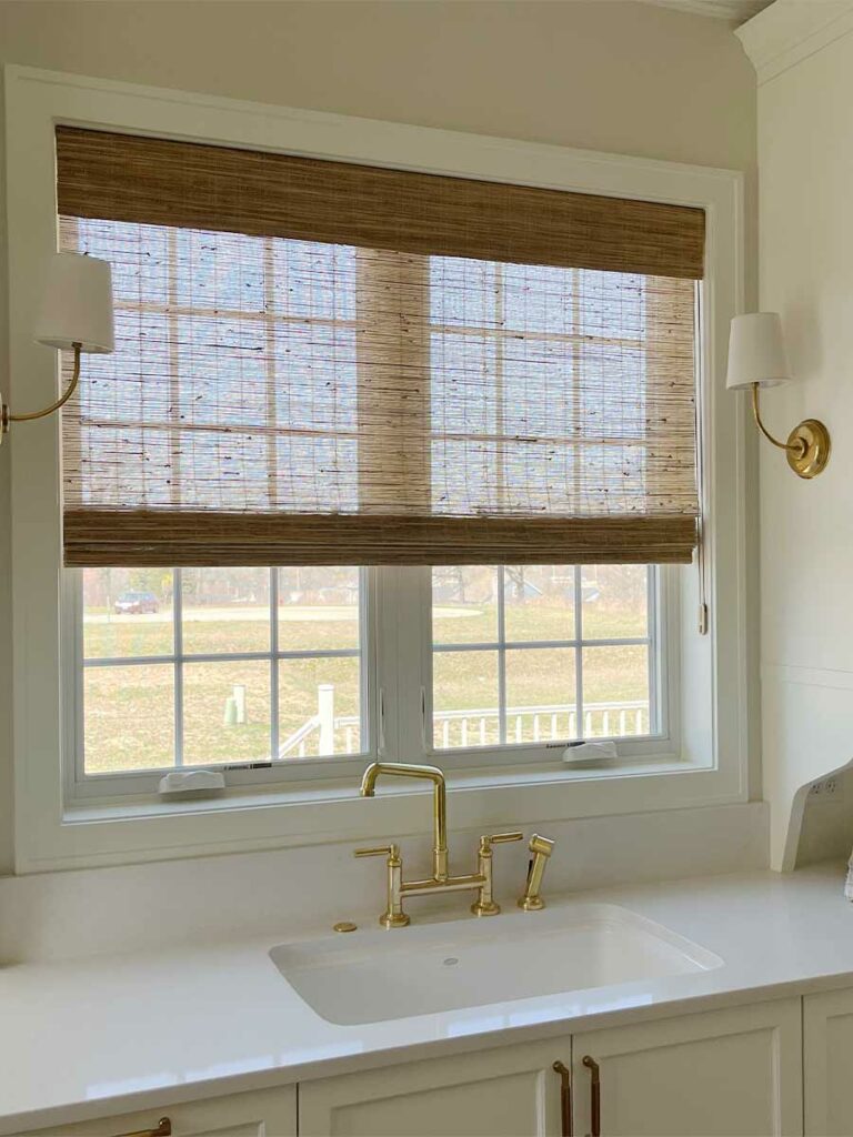 Natural woven shades on kitchen windows in a minimalist Brentwood, Tennessee home