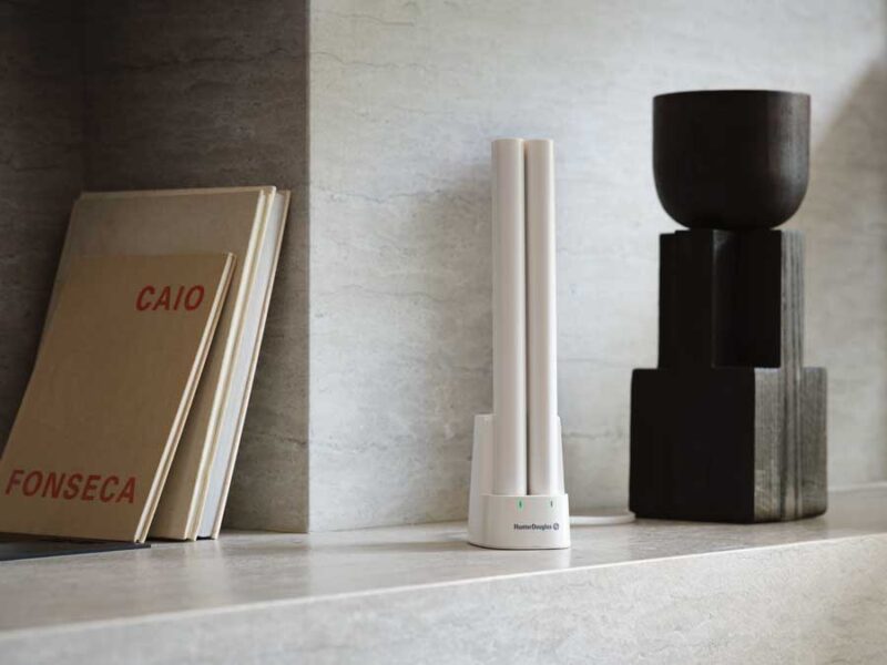 rechargeable battery wand on shelf charging two batteries for motorized roller shades