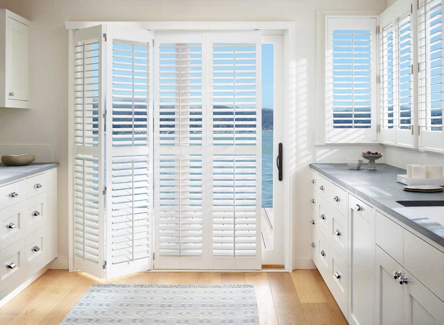 white vinyl shutters in kitchen with bi-fold opening operation on sliding door