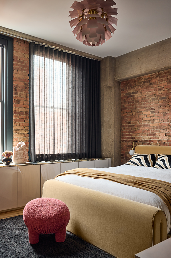 black drapery paired with designer roller shades in bedroom