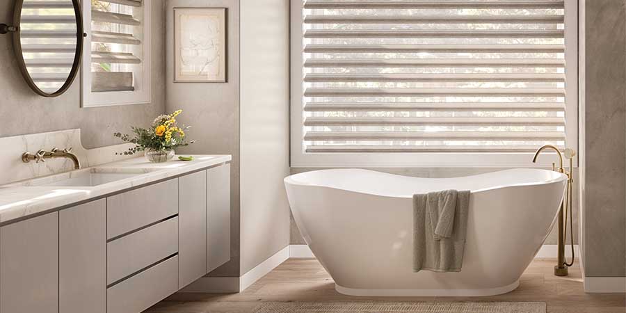 pirouette window shades on window behind tub for bedroom and bathroom privacy