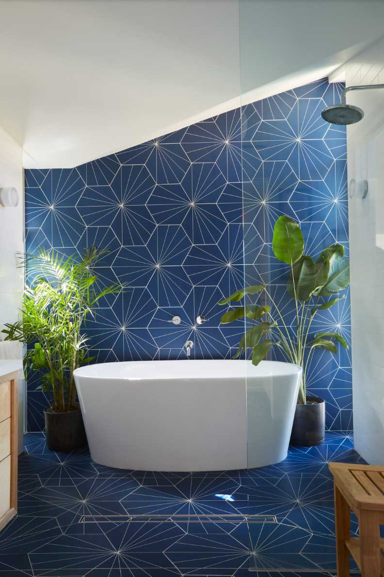 geometric tile wall in blue bathroom with sloped ceiling