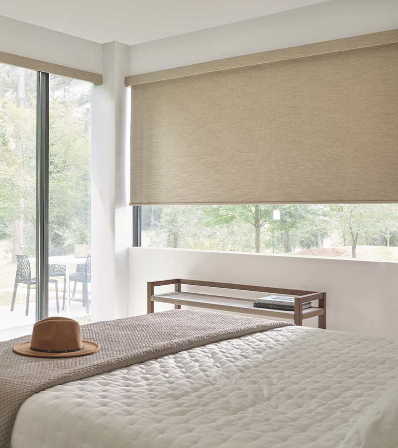 brown designer roller shades in bedroom