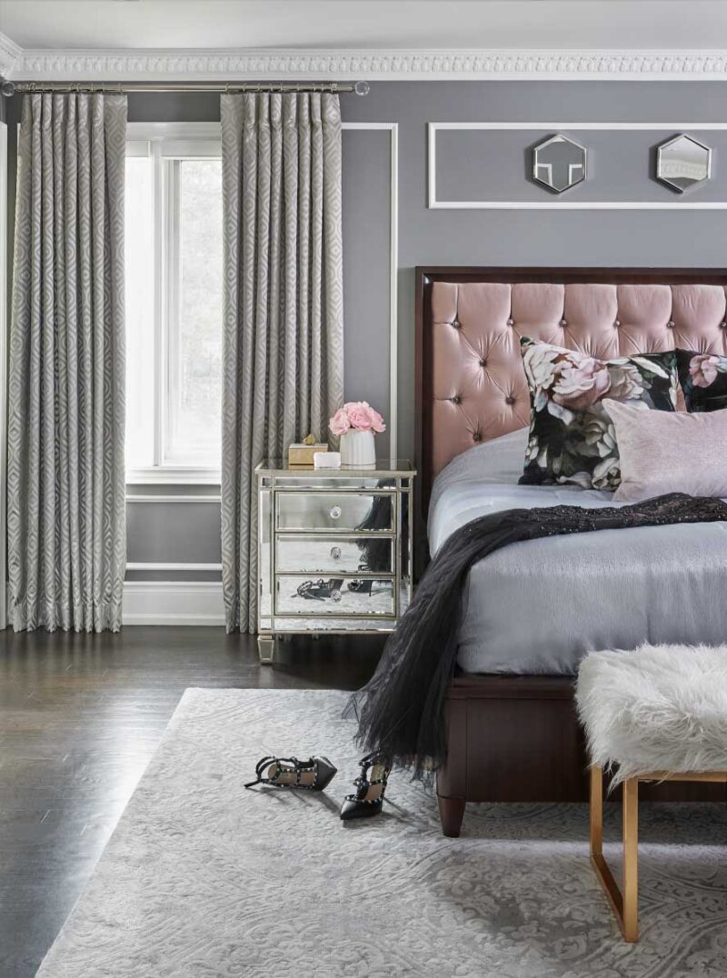 gray bedroom with pink upholstered headboard