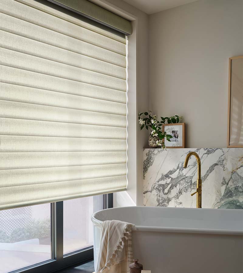 large-windows-bathroom-pirouette-hunter-douglas-custom-window-shades-blinds-skyline-window-coverings bathroom with white pirouette shades and white soaking tub