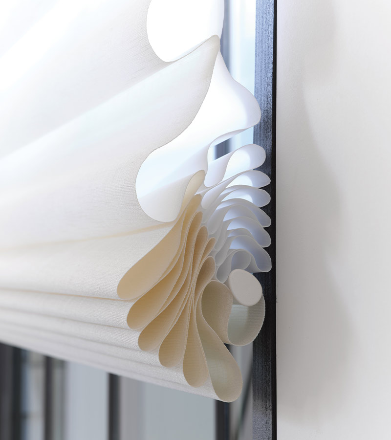 vignette-roman-shades-stacking-detail-hunter-douglas-skyline-window-coverings close up of stacking shades