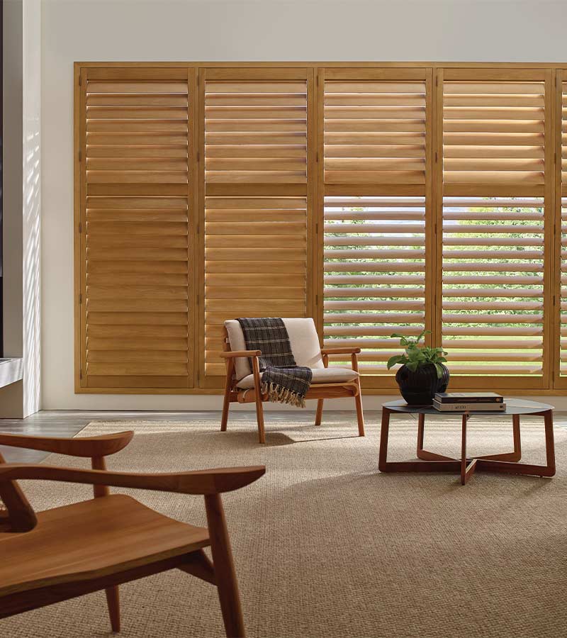 energy-efficient-heritance-hardwood-shutters-window-treatments-skyline-window-coverings wood shutters for large window in living room energy efficient