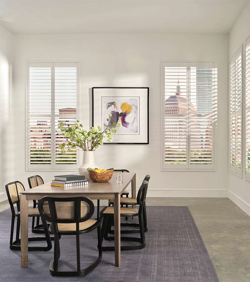 White Palm Beach™ vinyl shutters along a dining room wall