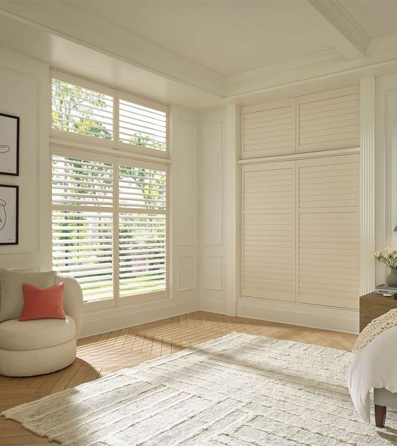 White vinyl interior shutters in a bedroom for light control
