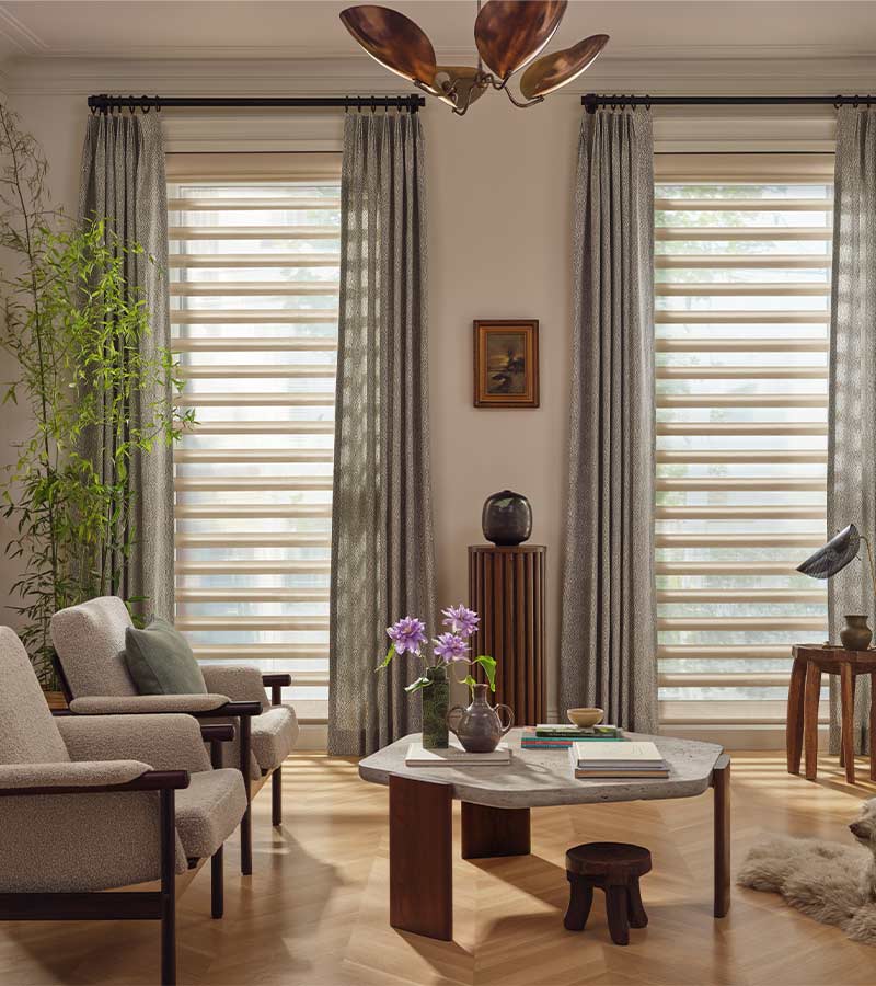 pirouette-window-treatments-living-room-drapery-layered-over-shades-hunter-douglas-skyline-window-coverings Pirouette window shades with curtains in living room during daylight