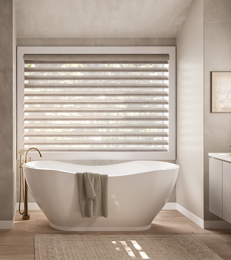 pirouette-window-treatments-primary-bathroom-suite-shades-privacy-options-hunter-douglas-skyline-window-coverings bathroom with tub and pirouette window treatments