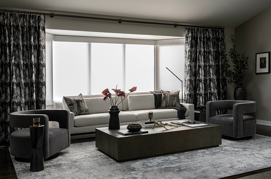 Chicago living room bay window with patterned inverse pinch pleat drapes and white light filtering roller shades