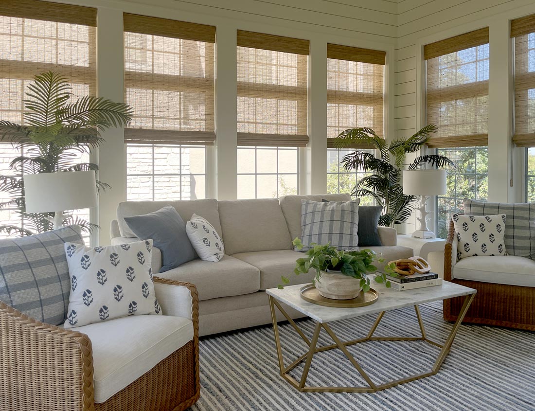 Provenance woven wood shades filtering daylight through wall-to-wall sunroom windows in Naperville