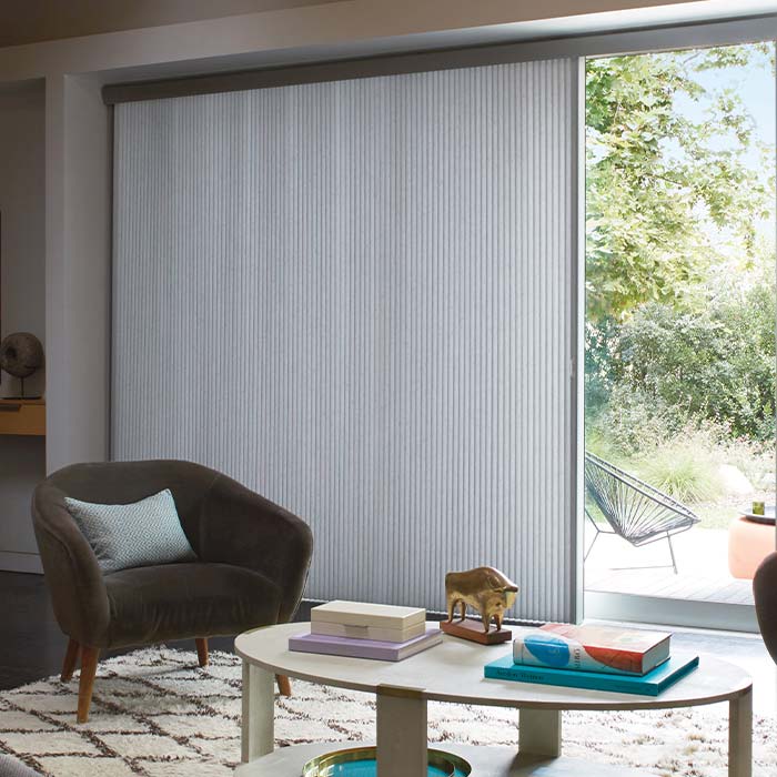 duette-vertiglide-vertical-window-coverings-skyline-hunter-douglas Duette® Vertiglide™ honeycomb shades covering large sliding glass doors in living room