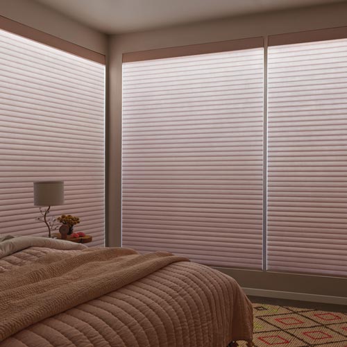 Aura illuminated Sonnette cellular roller shades on large windows with adjustable ambient lighting and light control